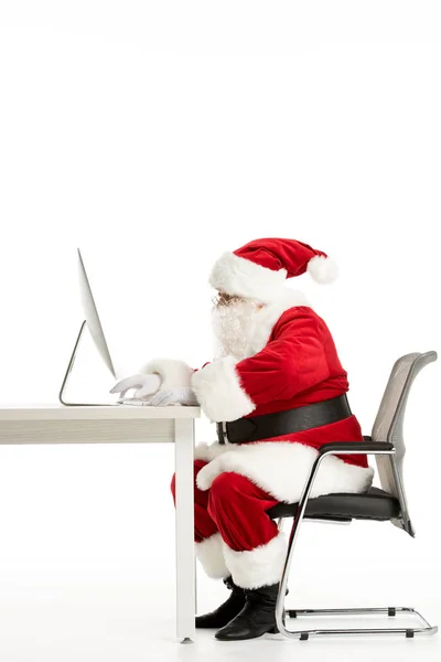 Santa Claus using computer — Stock Photo