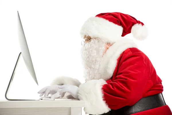 Santa Claus using computer — Stock Photo