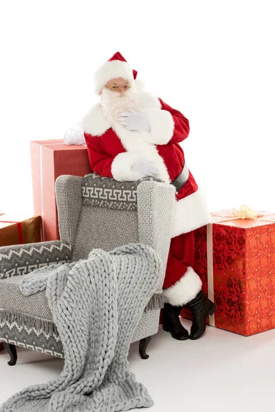 Santa Claus leaning on grey armchair — Stock Photo