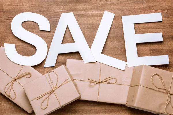 Sale sign with gift boxes — Stock Photo