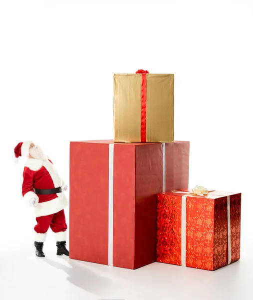 Santa Claus with pile of Christmas gifts — Stock Photo