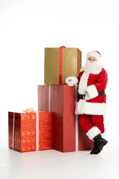 Santa Claus with pile of Christmas gifts — Stock Photo