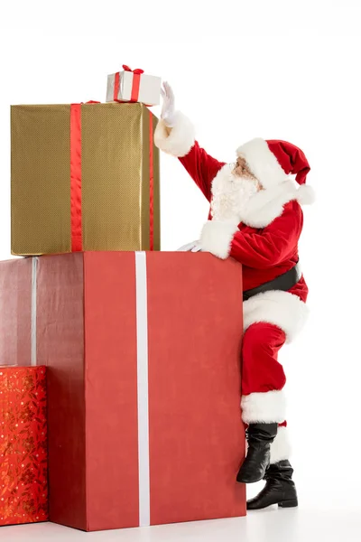 Santa Claus with pile of Christmas gifts — Stock Photo
