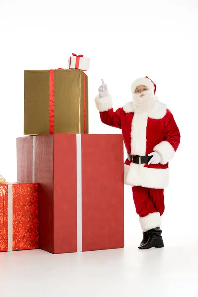 Santa Claus with pile of Christmas gifts — Stock Photo