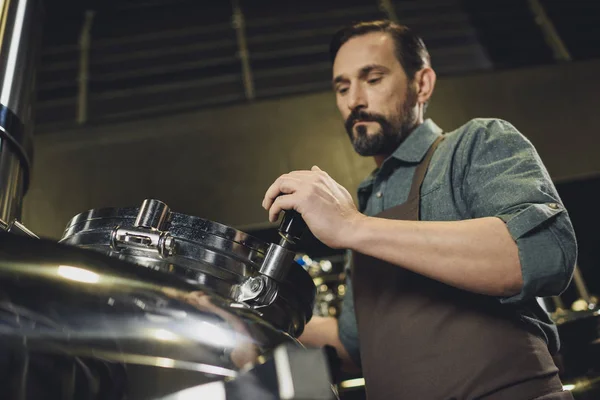 Brewer inspecting tank — Stock Photo