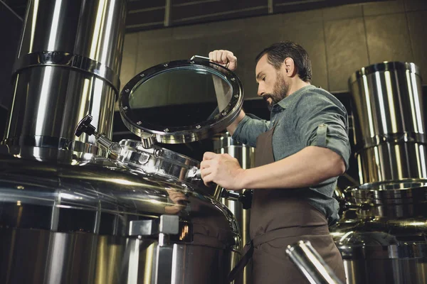 Brewer inspecting tank — Stock Photo