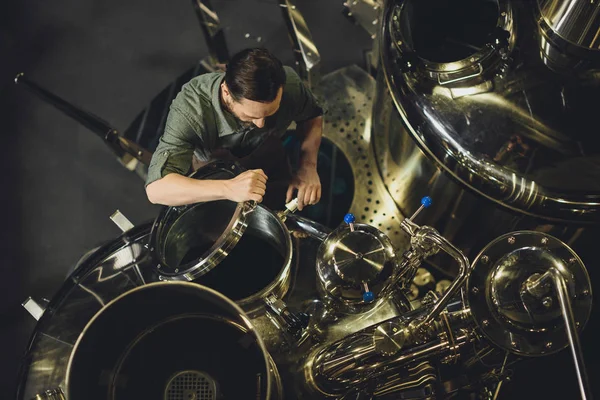 Brewer inspecting tank — Stock Photo