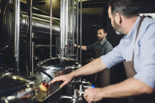 Brewers working with equipment — Stock Photo