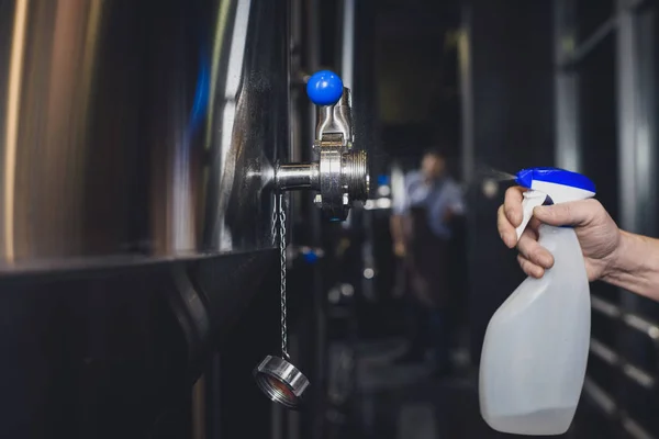 Worker cleaning brewery equipment — Stock Photo