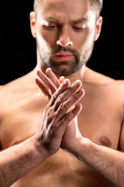 Shirtless man rubbing hands — Stock Photo
