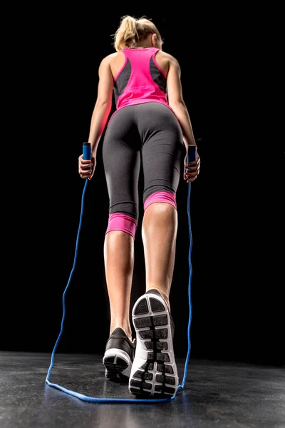 Sportswoman exercising with skipping rope — Stock Photo