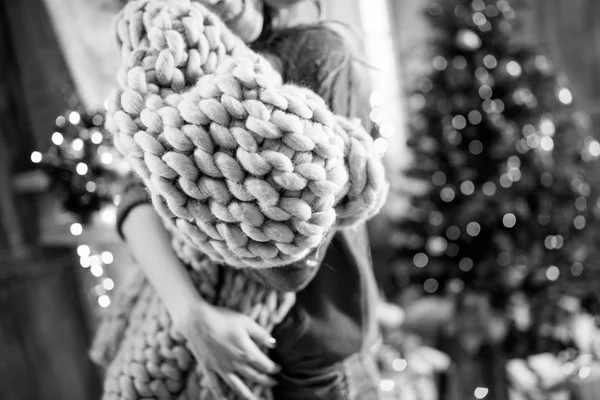 Young woman holding knitted cloth — Stock Photo