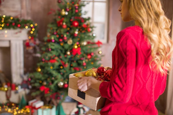 Woman holding box with baubles — Stock Photo