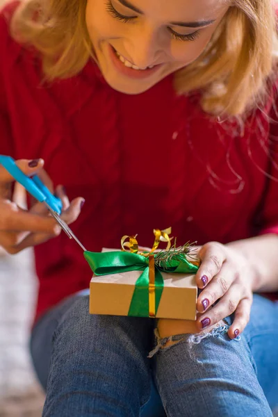 Girl wrapping gift box — Stock Photo