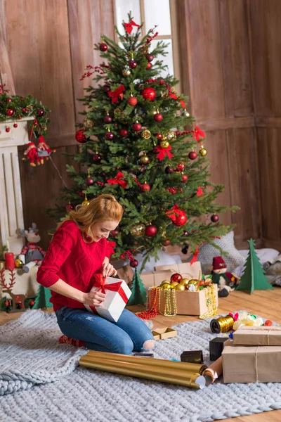 Girl wrapping gift box — Stock Photo