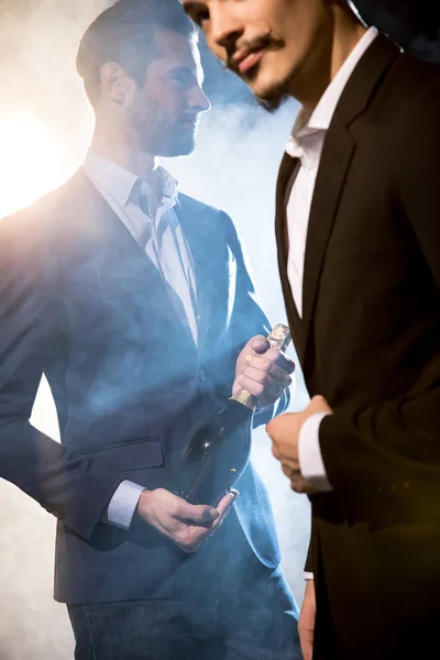 Stylish men with champagne bottle — Stock Photo