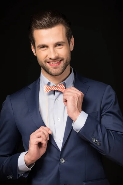 Man adjusting fake bowtie — Stock Photo