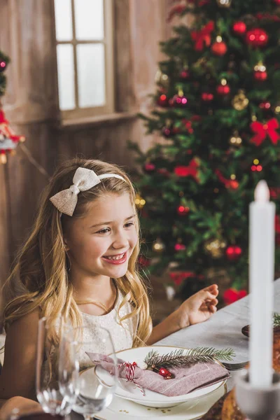 Cute girl at holiday table — Stock Photo