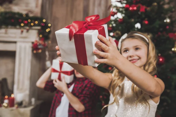 Niños abriendo cajas de regalo - foto de stock