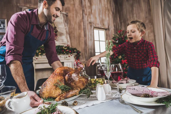 Father and son serving festive table — Stock Photo