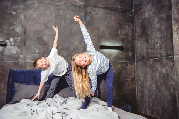 Siblings playing on bed — Stock Photo