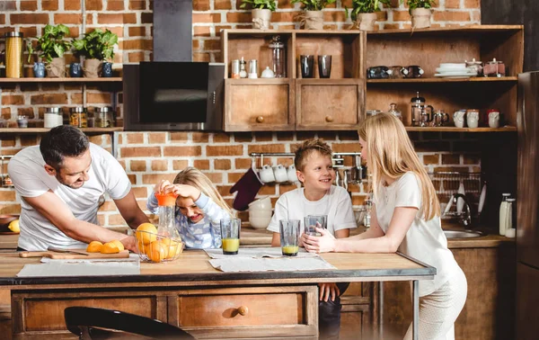 Familie stellt Orangensaft her — Stockfoto