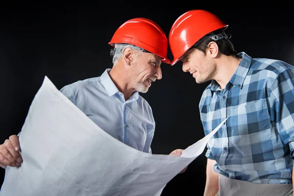 Engineer and architect in hard hats — Stock Photo