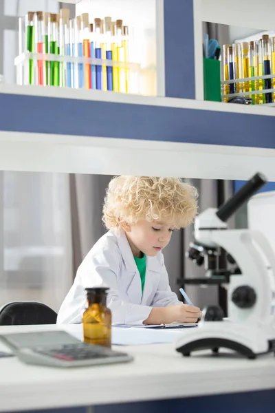 Schoolboy taking notes — Stock Photo