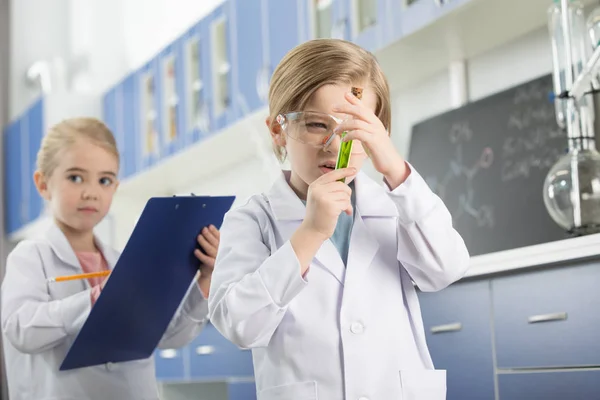 Schoolboy looking at sample — Stock Photo