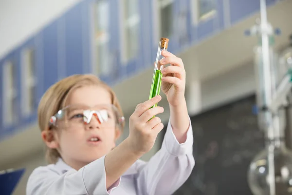 Schoolboy looking at sample — Stock Photo