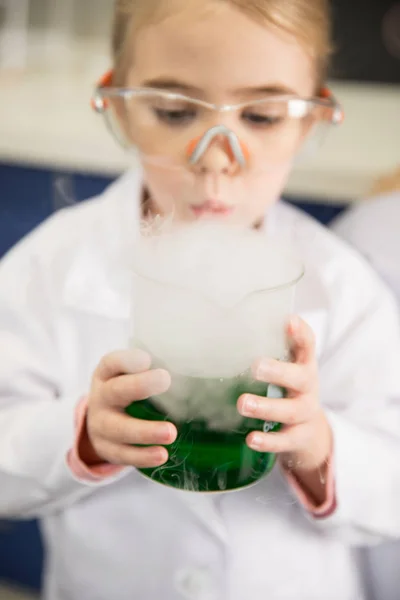 Schoolgirl holding flask — Stock Photo