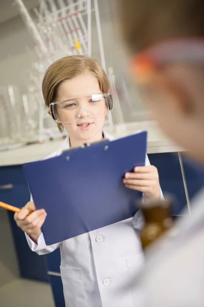 Schoolboy taking notes — Stock Photo