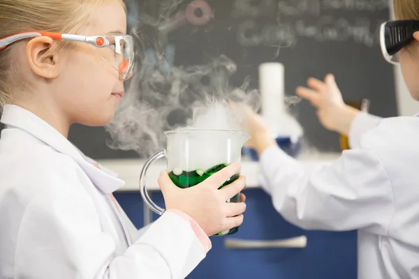 Schoolgirl holding flask — Stock Photo