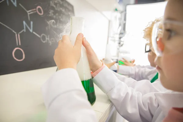 Schoolgirl holding flask — Stock Photo