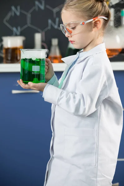 Girl holding flask with reagent — Stock Photo
