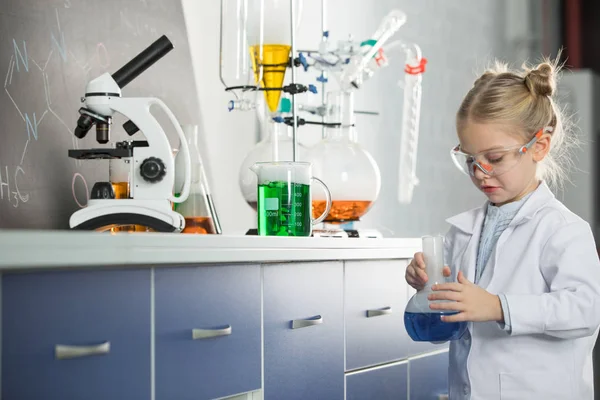 Girl holding flask with reagent — Stock Photo