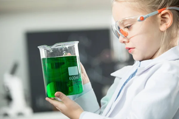 Girl holding flask with reagent — Stock Photo