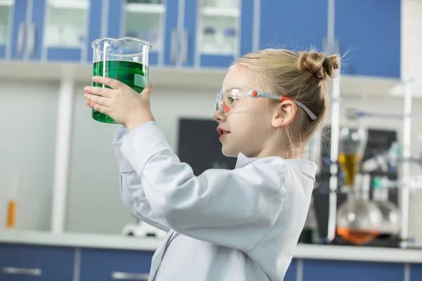 Girl holding flask with reagent — Stock Photo