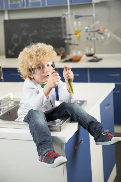 Boy sitting in sink — Stock Photo