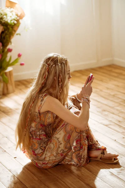 Woman in boho style using smartphone — Stock Photo