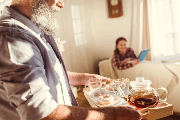 Man holding tray with tea — Stock Photo