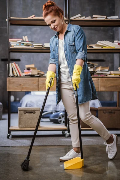 Woman sweeping floor — Stock Photo