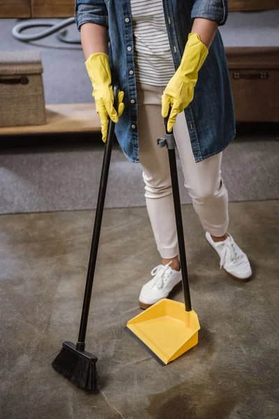 Woman sweeping floor — Stock Photo