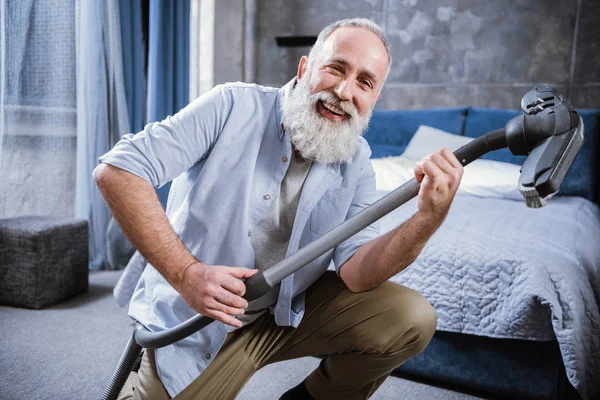 Man with vacuum cleaner — Stock Photo