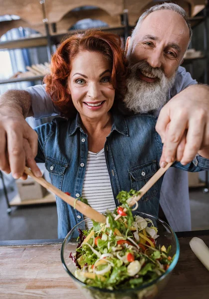 Couple cooking vegetable salad — Stock Photo