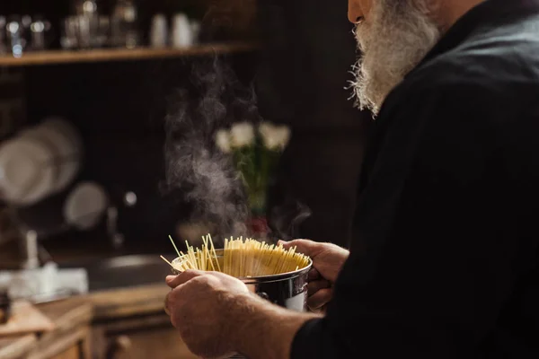 Hombre cocinando espaguetis - foto de stock