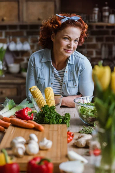 Mature woman in kitchen — Stock Photo