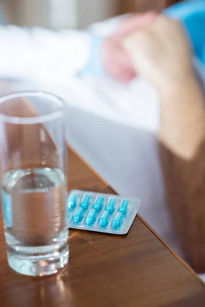 Glass of water and pills — Stock Photo