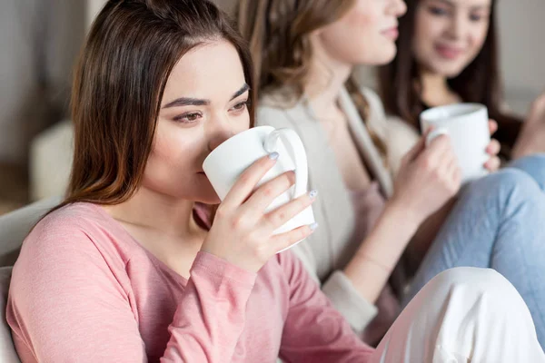 Women holding cups — Stock Photo