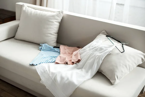 Clothes lying on sofa — Stock Photo